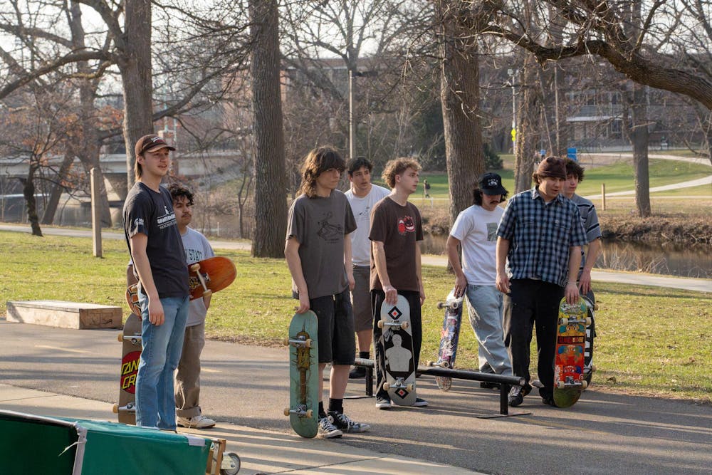 Members of MSU Skate Club laugh and converse between tricks, highlighting the community within the club, during skate club outside of Shaw Hall on Michigan State University’s campus in East Lansing, Mich., on March 20, 2026, 