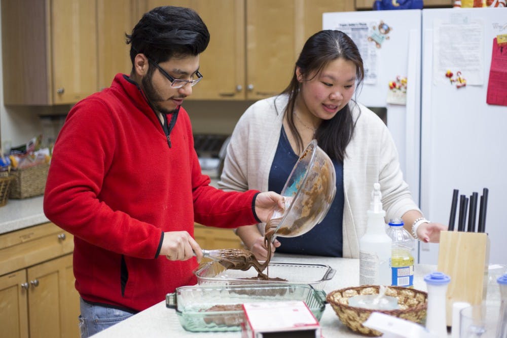 Left, biochemistry junior Jose Sanchez, and interdisciplinary studies and public policy sophomore Xue Lin Wang make brownies on Jan. 30, 2017 at Ronald Mcdonald House at 121 S. Holmes St. in Lansing. Sanchez and Wang are a part of the on-campus group called Spartans Rebuilding Michigan. The group consists of over 200 students who complete 10 volunteer projects a week.