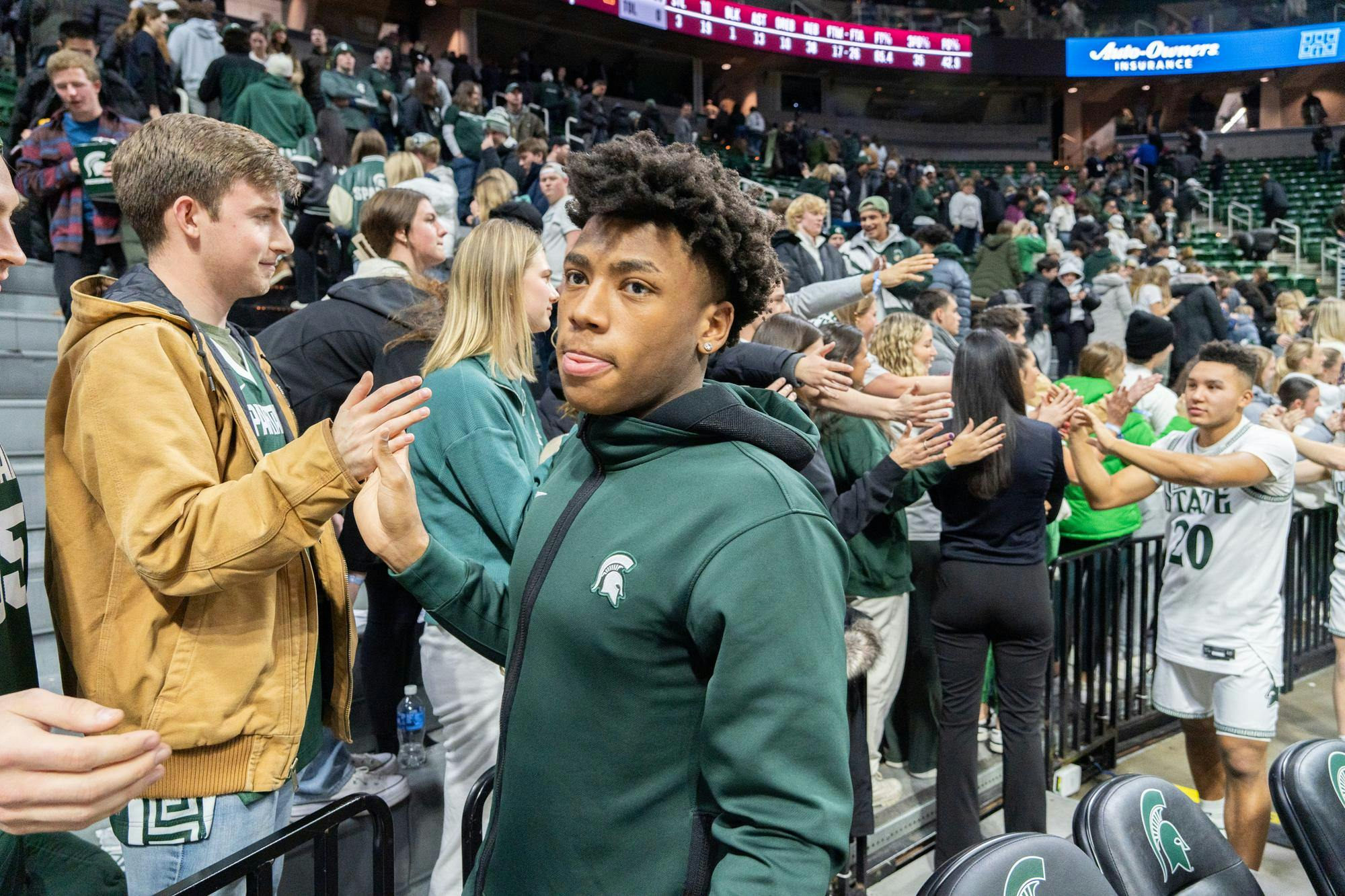 MSU guard Jeremy Fears Jr. gives out high fives to fans after a win at home at the Breslin Center in East Lansing on Thursday, Jan. 18, 2024. Fears, 18, is recovering from an injury after being shot in his hometown of Joliet, Illinois.