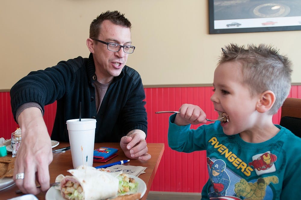 	<p>Law student Allen Clarkson talks to his son Finney Clarkson, 5, as he eats April 17, 2013, at Spencer&#8217;s Kitchen and Bar, 313 E. Grand River Ave. Clarkson said he and his family have been waiting all winter for the restaurant to open. Julia Nagy/The State News</p>