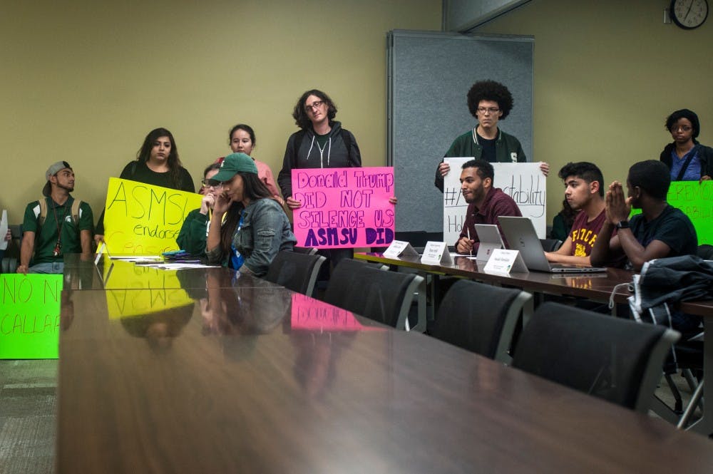 Protesters surround an ASMSU meeting on Oct. 12, 2016 in the Student Services Building. The protest was carried out in response to recent ASMSU actions involving presidential candidate speaking invitations. 