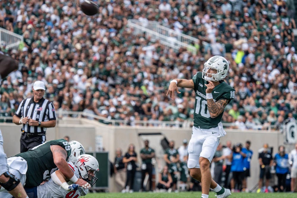 <p>Quarterback Noah Kim (10) passes the ball to wide receiver Tre Mosley (17) for a touchdown during a game against Richmond at Spartan Stadium on Sept. 9, 2023. The Spartans ultimately defeated the Spiders 45-14.</p>