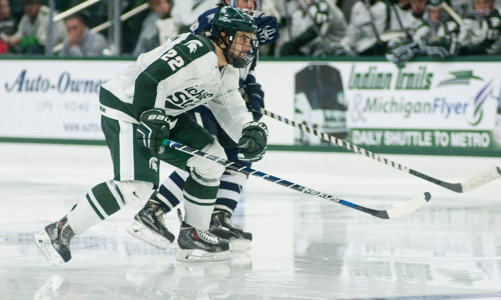 <p>Junior forward JT Stenglein skates down the ice during the game against New Hampshire on Nov. 7, 2015, at Munn Ice Arena. The Spartans defeated the Wildcats, 7-4. </p>