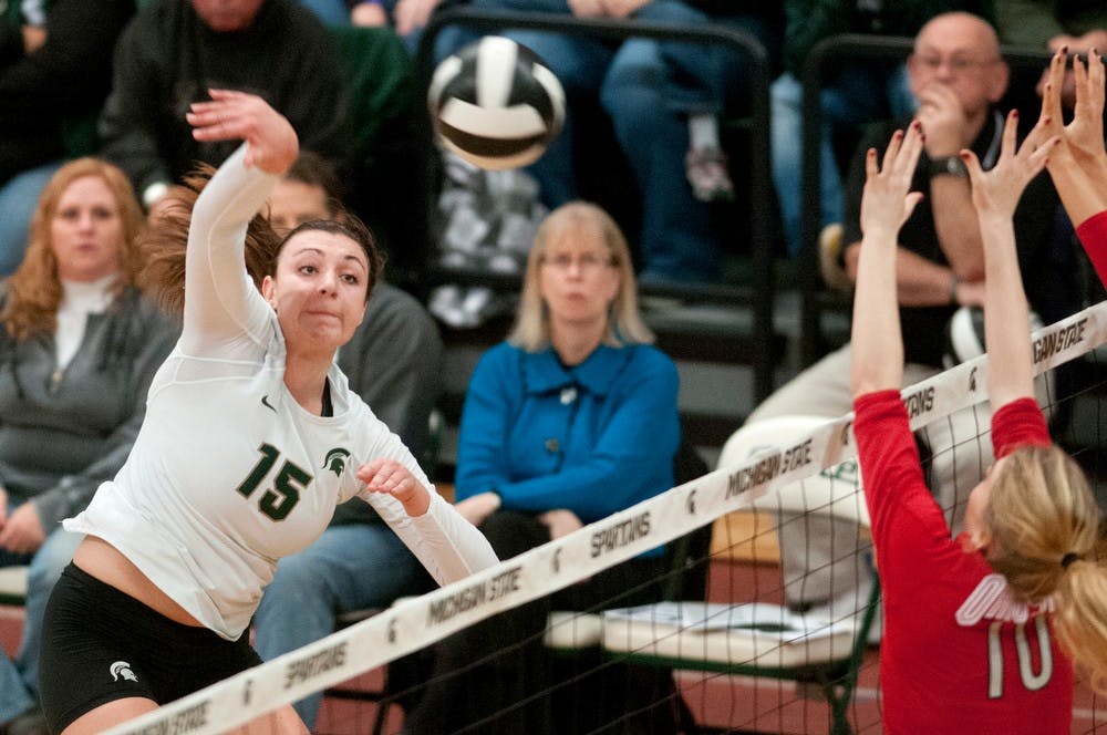 	<p>Senior outside hitter Lauren Wicinski hits the ball as Ohio State middle blocker Taylor Sandbothe tries to block Nov. 1, 2013, during the game against Ohio State at Jenison Field House. The Spartans defeated the Buckeyes, 3-0. Julia Nagy/The State News </p>