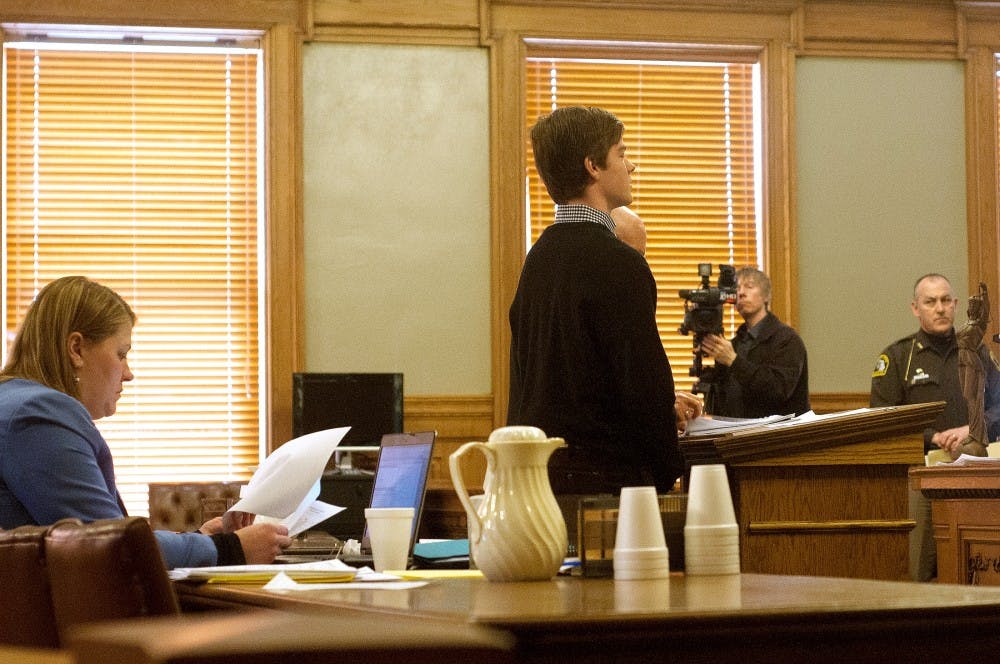 <p>MSU Alumnus Matthew Mullen stands with defense attorney Frank Reynolds March 4, 2015, at Ingham County 55th District Court, 700 Buhl St. in Mason. Mullen was sentenced to two years probation and restitution payments for an alleged terrorist post on Yik Yak last year. Kennedy Thatch/The State News</p>