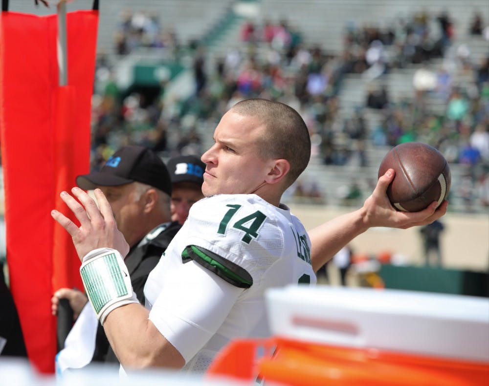 Senior quarter back Brian Lewerke (14) warming up during the Green and White game at Spartan Stadium on April 13, 2019. The green team defeated the white team 42-26.