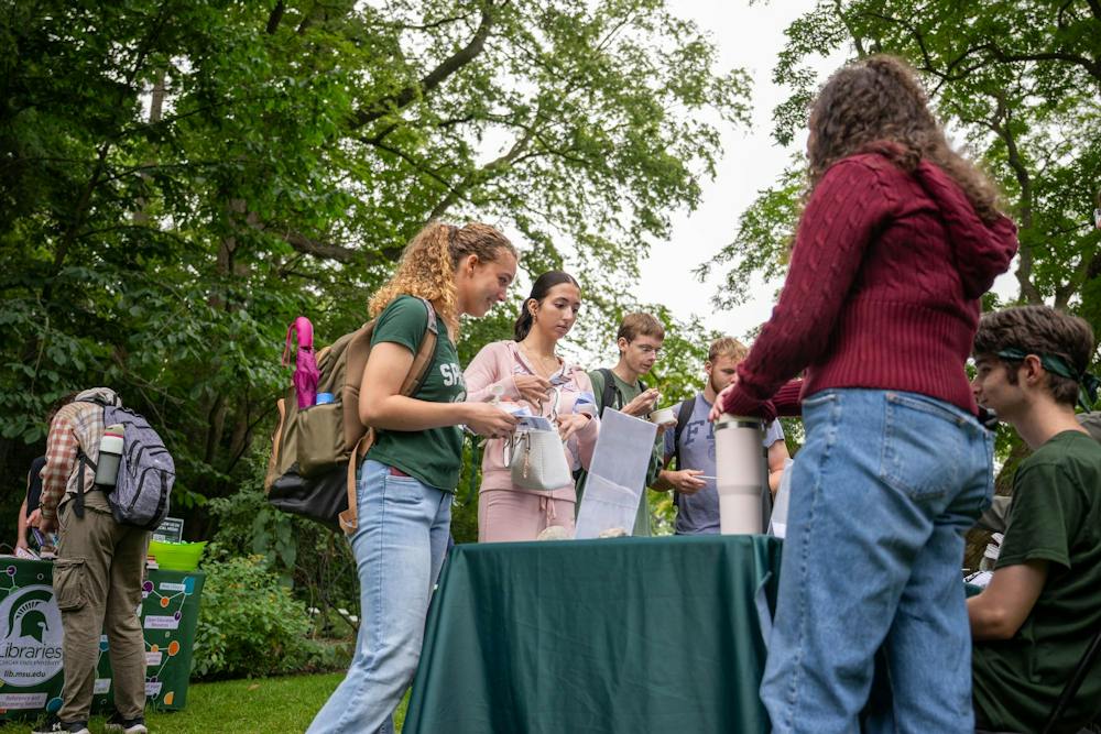 <p>Students visit the Michigan State University Sustainability booth during BealFest at the Beal Botanical Garden in East Lansing, Mich., on Thursday, Sept. 17, 2026.</p>