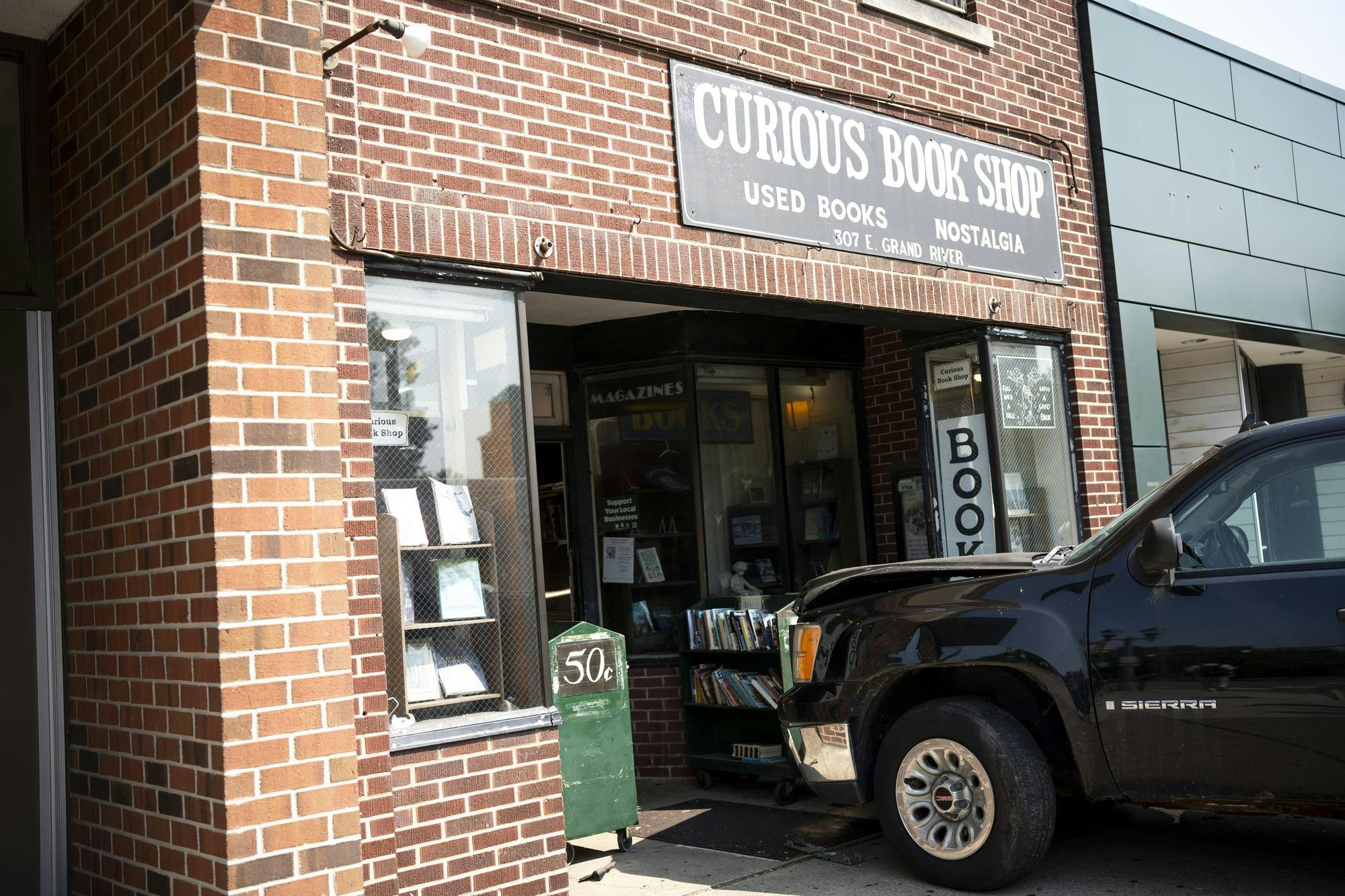 Pickup truck crashes into Curious Book Shop on Grand River Thursday afternoon.