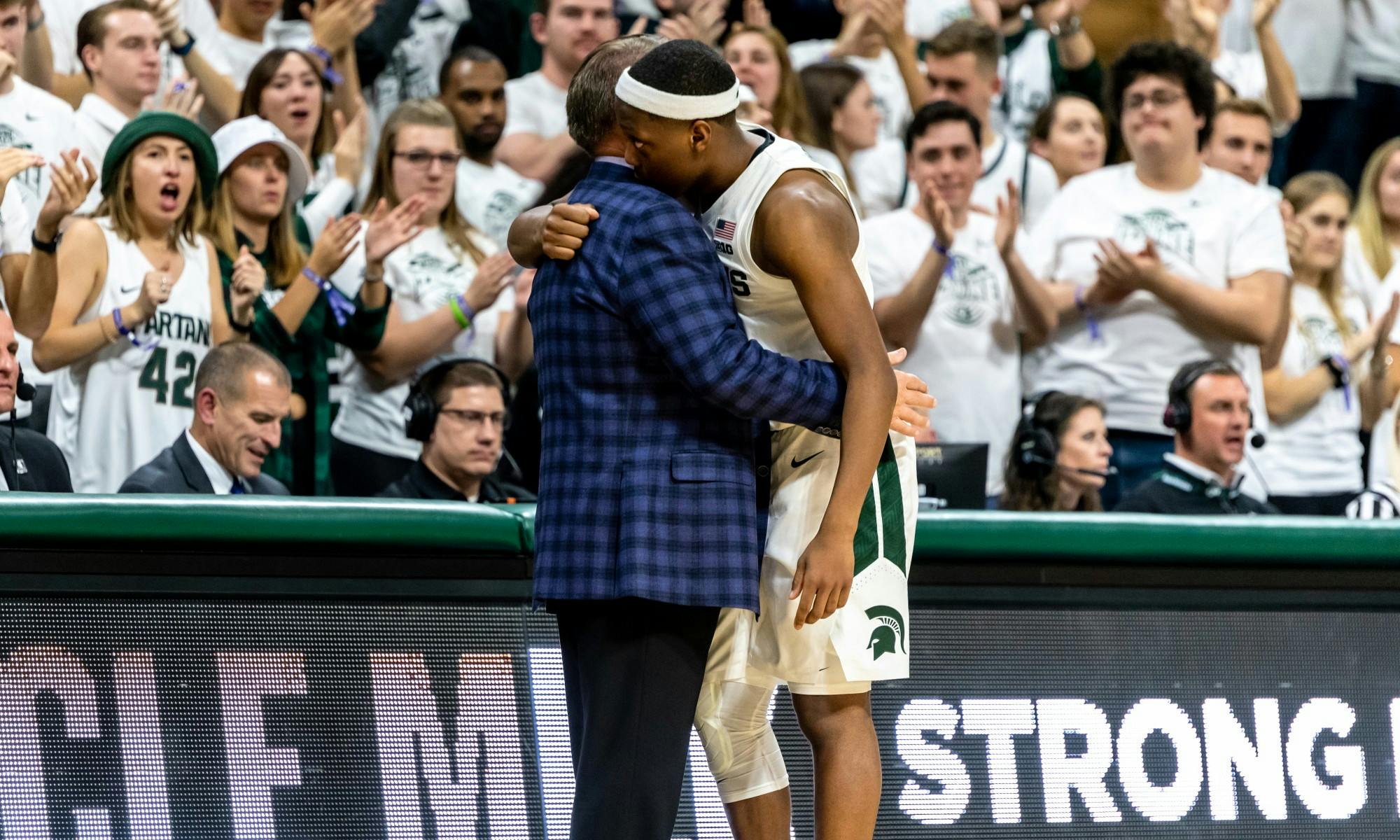 <p>Senior guard Cassius Winston (right) hugs coach Tom Izzo after being subbed out against Binghamton. The Spartans defeated the Bearcats 100-47 on Nov. 10, 2019 at the Breslin Student Events Center.</p>