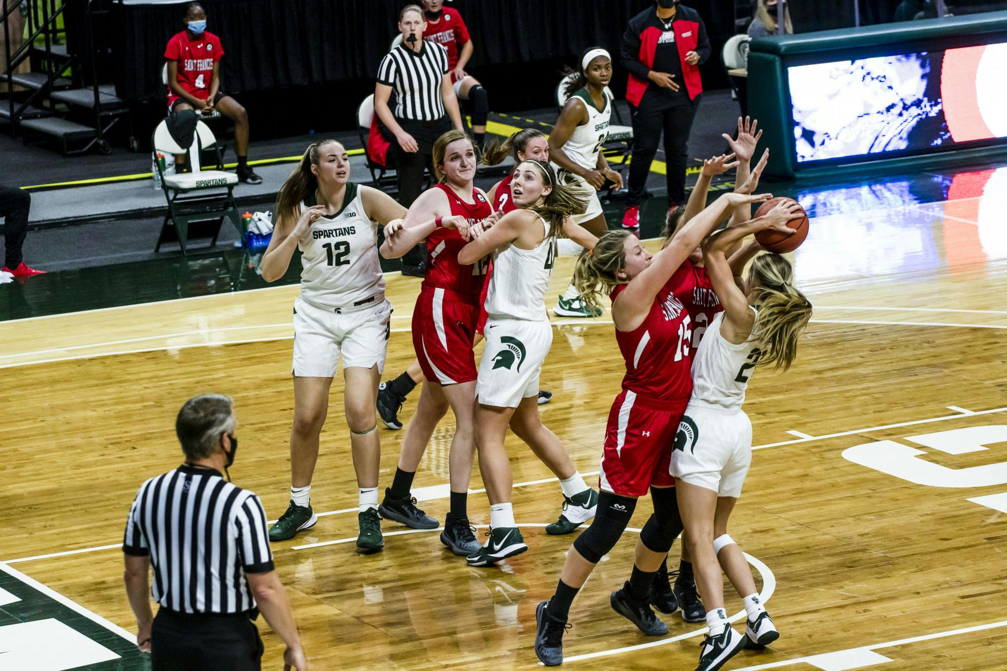 <p>Laurel Jacqmain (21) holds the ball despite defense by St. Francis on Nov. 27, 2020.</p>