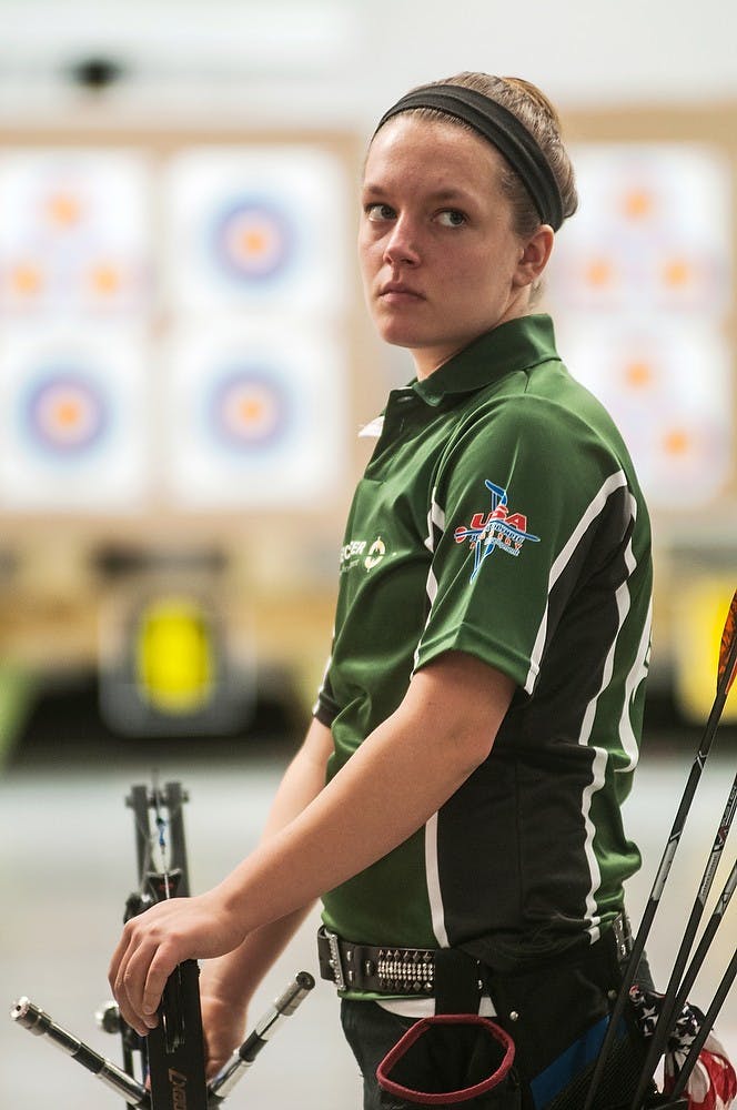 <p>Grand Blanc, Mich., resident Sarah Strickland looks into the crowd of spectators before she takes her turn March 1, during the National Archery Championship competition at the Demmer Shooting Sports, Education and Training Center. Archers came from all over the country to compete. The competition involved competitors shooting at a collection of four targets in a series of rounds. Erin Hampton/The State News</p>