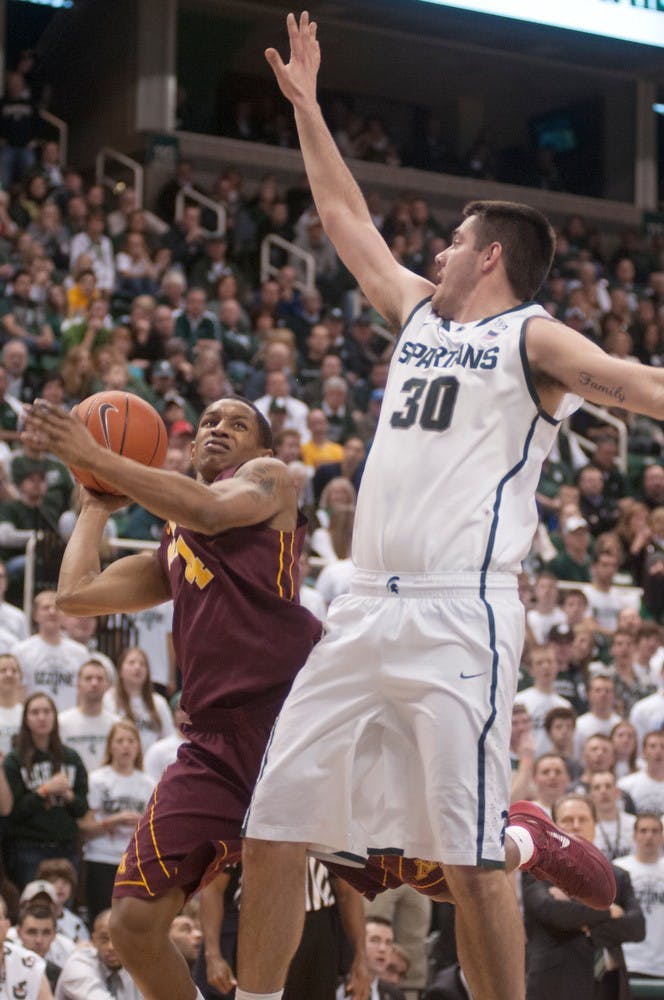 	<p>Freshman forward Kenny Kaminski guards Minnesota guard DeAndre Mathieu on Jan. 11, 2014, at Breslin Center. <span class="caps">MSU</span> beat Minnesota in overtime, 87-75. Julia Nagy/The State News</p>