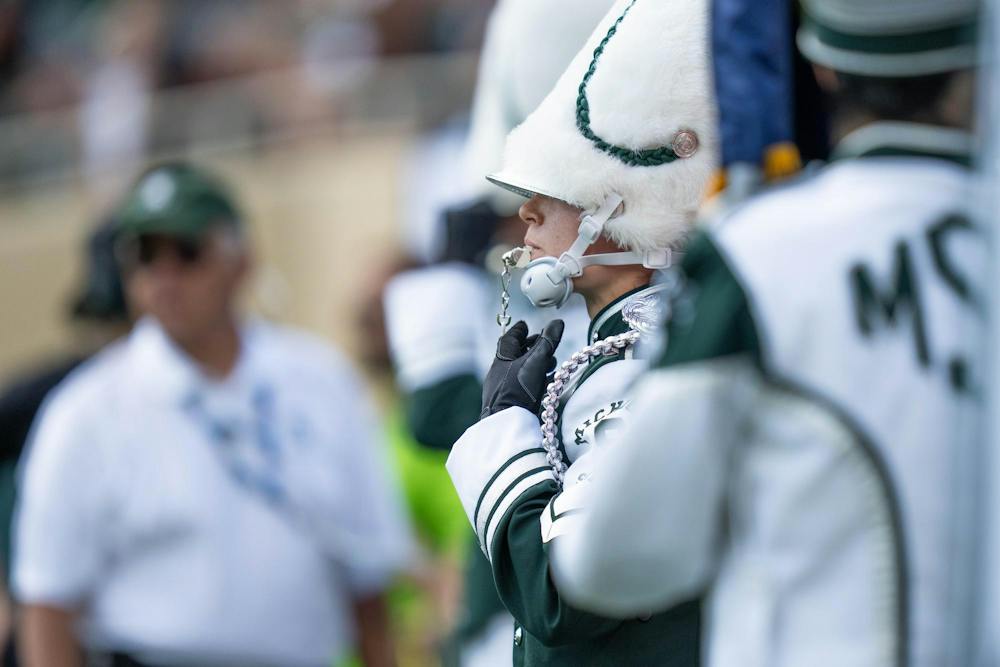 <p>Michigan State University Marching Band drum major waits at the field entrance at the north end zone of Spartan Stadium, awaiting the opening performance of MSU's game against Eastern Michigan in East Lansing, Mich., on Sept. 12, 2026.</p>