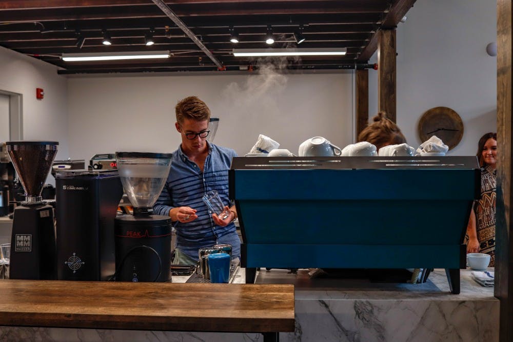 <p>An employee prepares free coffee for those at the press release event at Foster Coffee Co in East Lansing on Sept. 11, 2019.</p>