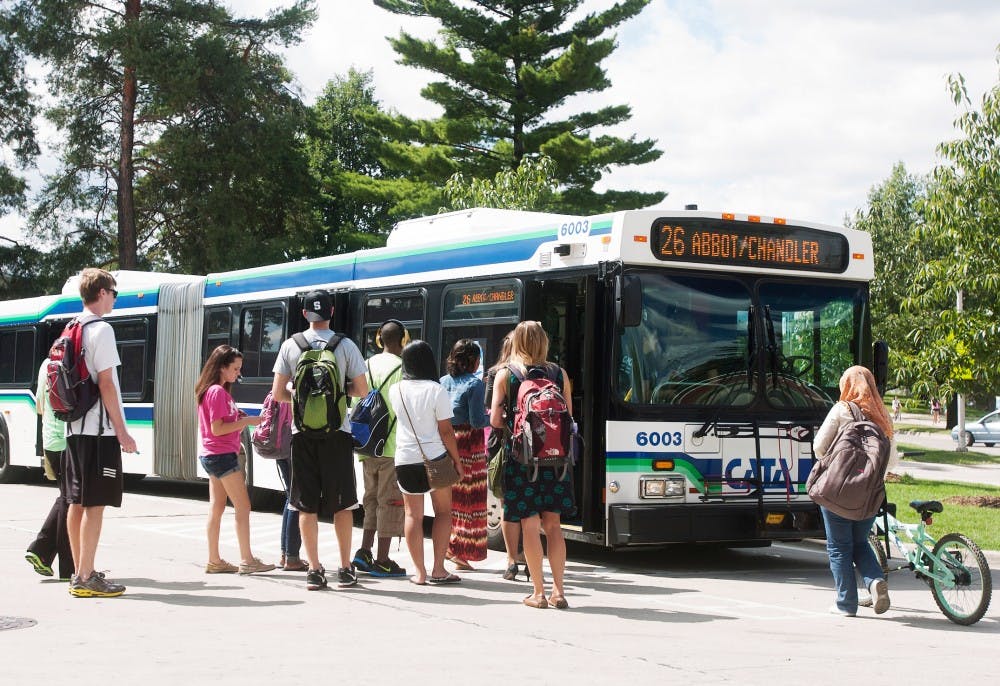 MSU students board a bus at the CATA bus station on Shaw Lane. Since CATA began in 1972, it has given approximately 11.85 million rides. Griffin Zotter/The State News