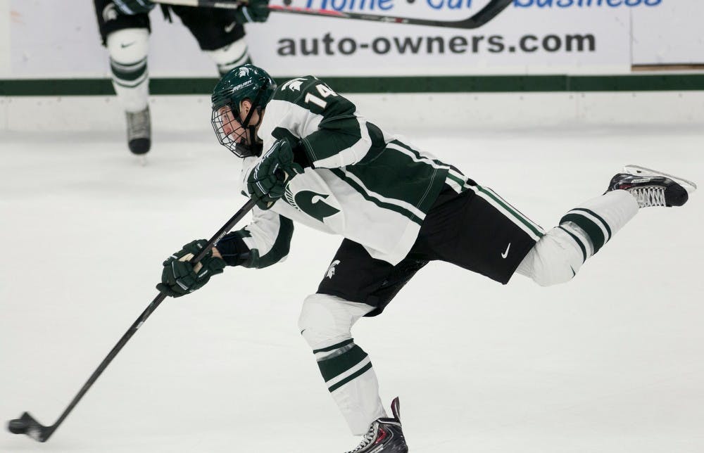 	<p>Senior defender Nickolas Gatt passes the puck out of Spartan territory during the game against Western Ontario on Oct. 9, 2013, at Munn Ice Arena. The Spartans defeated the Mustangs, 4-1. Danyelle Morrow/The State News</p>