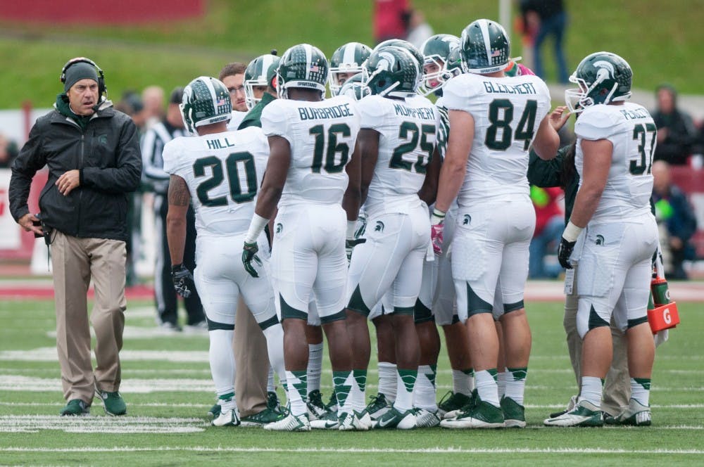 <p>Head coach Mark Dantonio approaches his team during a timeout against Indiana on Oct. 18, 2014, at Memorial Stadium in Bloomington, Ind. The Spartans defeated the Hoosiers, 56-17.</p>