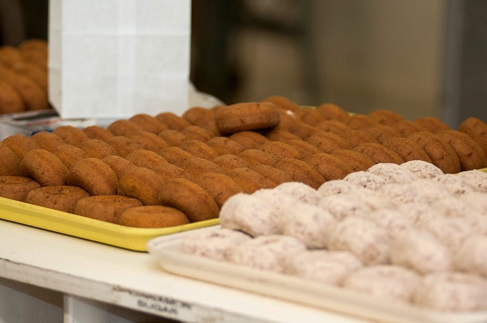 <p>Fresh donuts are made on Oct. 29, 2014, at Uncle John's Cider Mill, 8614 U.S. 127, in St. Johns, Mich. Aerika Williams/The State News </p>