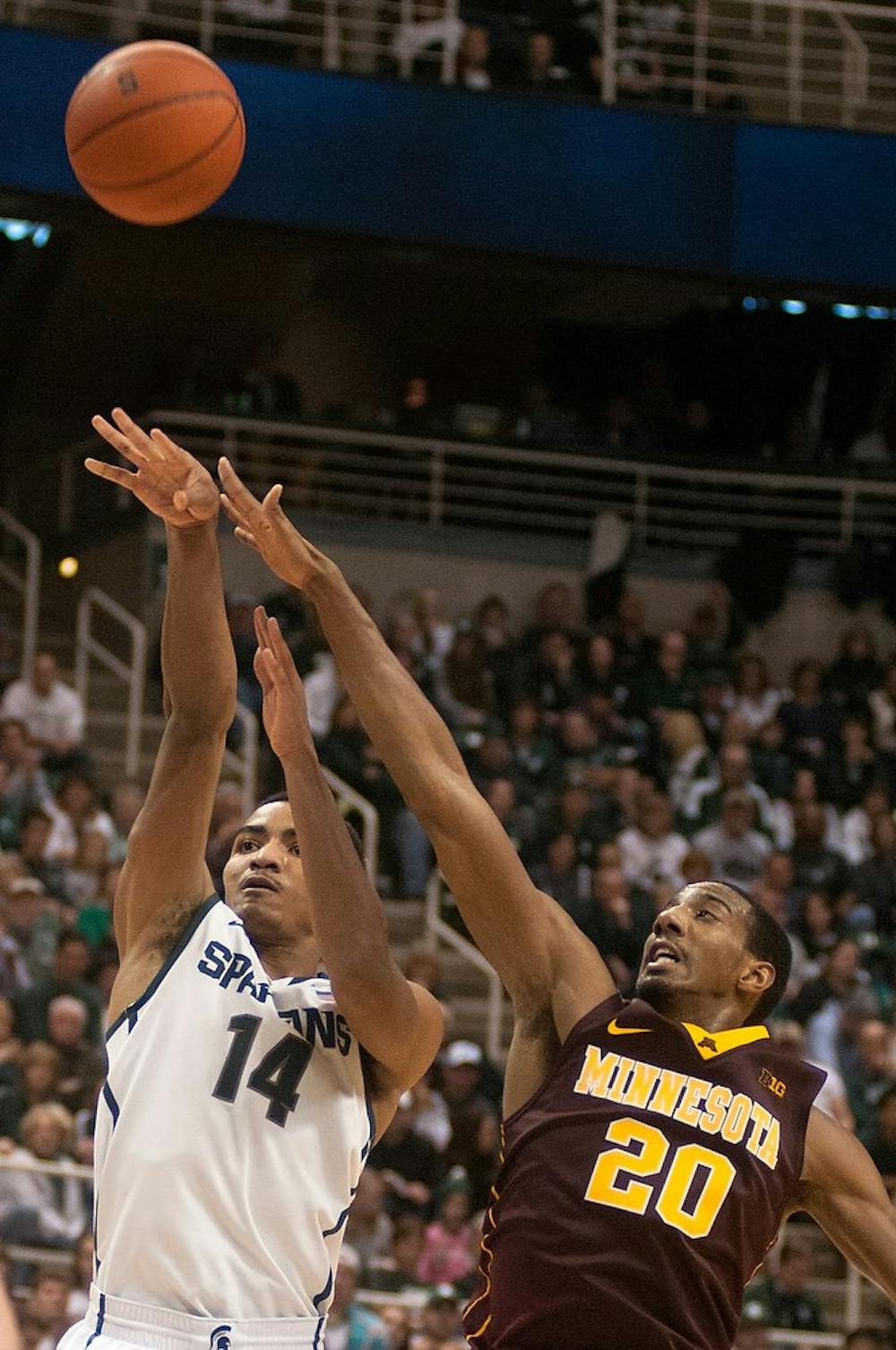 	<p>Sophomore guard Gary Harris shoots as Minnesota guard Austin Hollins tries to block Jan. 11, 2014, at Breslin Center. The Spartans defeated the Golden Gophers in overtime, 87-75. Julia Nagy/The State News</p>