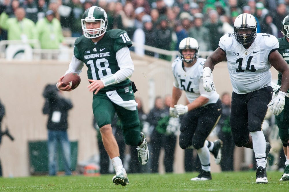 <p>Senior quarterback Connor Cook rushes for 22 yards and gains a first down in the third quarter during the Homecoming game against Purdue on Oct. 3, 2015 at Spartan Stadium. The Spartans defeated the Boilermakers, 24-21.</p>
