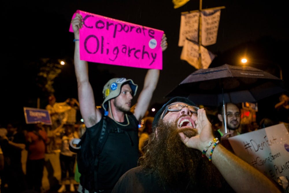 A protester chants along with others on July 28, 2016, the fourth day of the Democratic National Convention, outside of Wells Fargo Arena in Philadelphia.