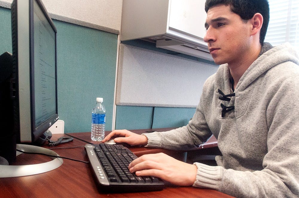 	<p>Computer science and engineering sophomore Zachary Ray edits an <span class="caps">HTML</span> code on Tuesday, Feb. 26, 2013, in the Office of Financial Aid, located in Student Services Building. Ray has been working for the office for a semester and a half in order to gain experience. Danyelle Morrow/The State News</p>