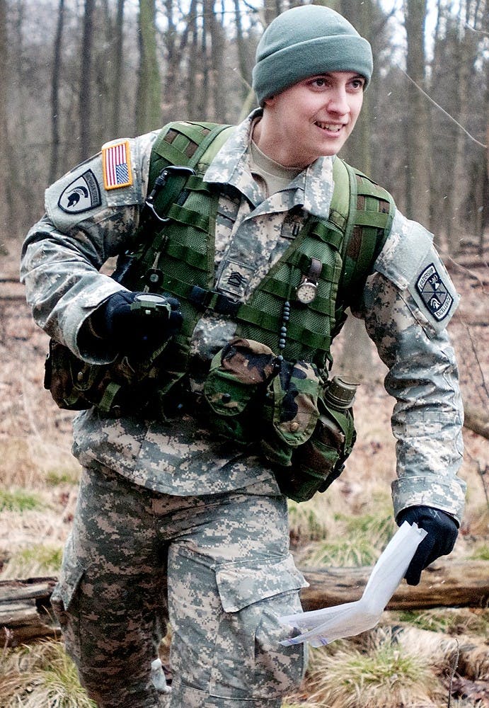 English junior Caleb Pyle makes his way through a wooded area owned by the Army ROTC in Okemos on Dobie Road in Okemos on Tuesday, March 12, 2013, to test navigational skills. The cadets used pace counts and compasses to find pre-set coordinates. Danyelle Morrow/The State News