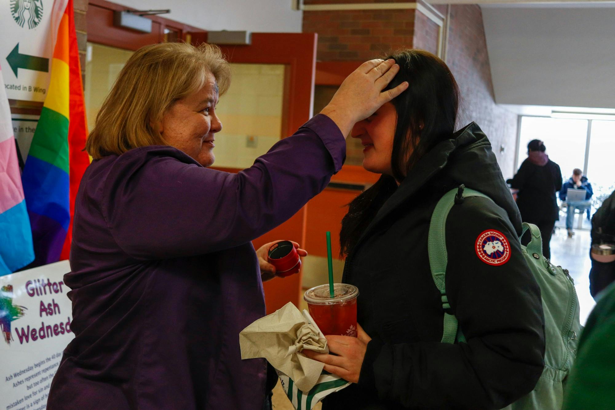 <p>Rev. Donna McNiel marks a student’s forehead in Wells Hall at the Glitter Ash Wednesday event put on by Canterbury MSU, All Saints Episcopal Church and Edgewood United Church of Christ on Feb. 26, 2020.</p>