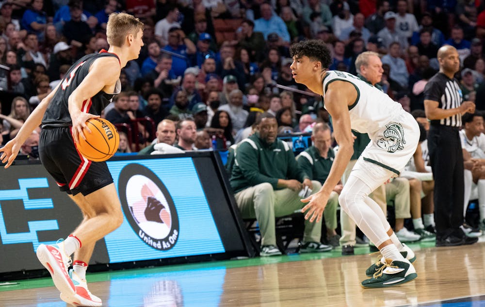 <p>Freshman guard Max Christie (5) defends against sophomore guard Grant Huffman (5) during Michigan State&#x27;s win over the Davidson Wildcats on March 18, 2022.</p>