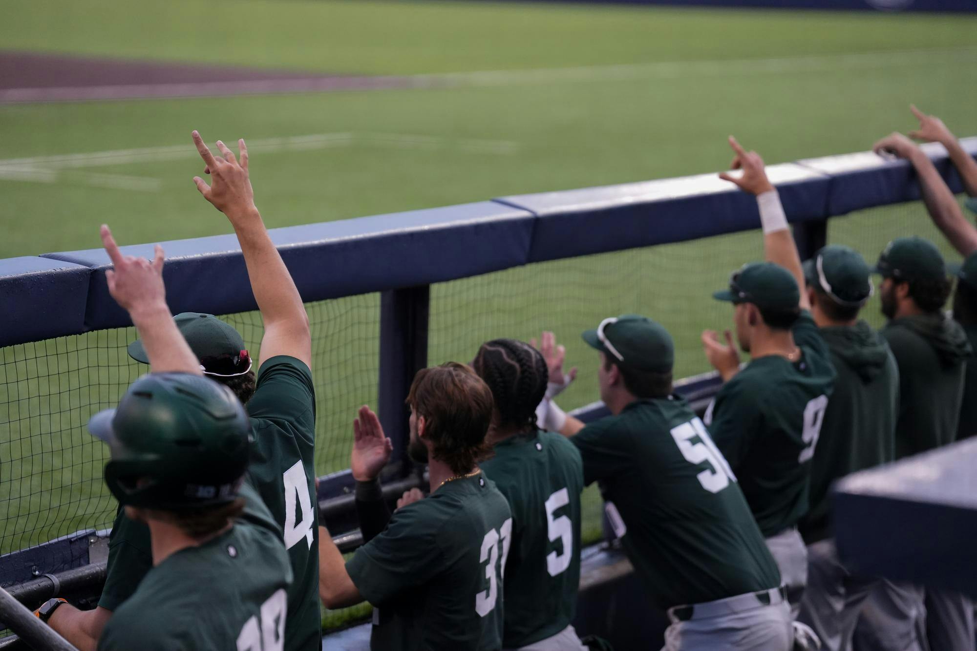 <p>Michigan State players cheer on a teammate from the dugout at Ray Fisher Stadium in Ann Arbor on April 25, 2025.</p>