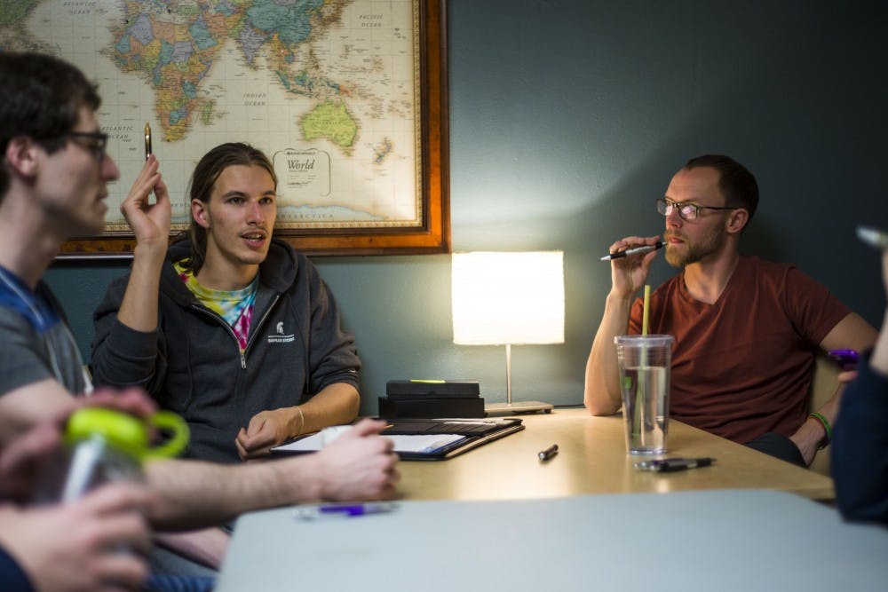 Environmental studies and sustainability junior Taylor Struna, left, leads a discussion during the MSU Traveler's Club meeting on March 31, 2017 at Olin Health Center. The MSU Traveler's Club is a club that provides a social space and support for people who are in recovery from addiction. 
