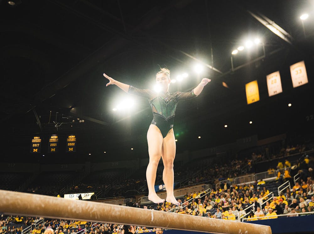MSU freshman all-around Korynne Marquart jumps on the balance beam at the Crisler Center in Ann Arbor, MI, on Feb. 01, 2026.
