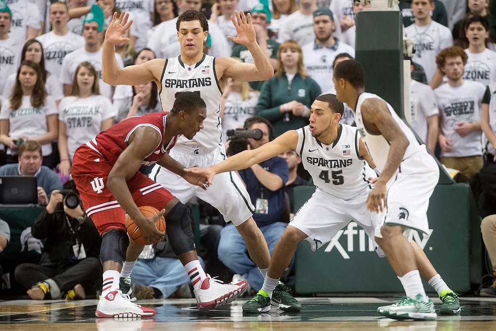 	<p>Freshman forward Gavin Schilling and sophomore guard Denzel Valentine guard Indiana freshman forward Noah Vonleh on Jan. 21, 2014, at Breslin Center. The Spartans defeated the Hoosiers, 71-66. Julia Nagy/The State News</p>