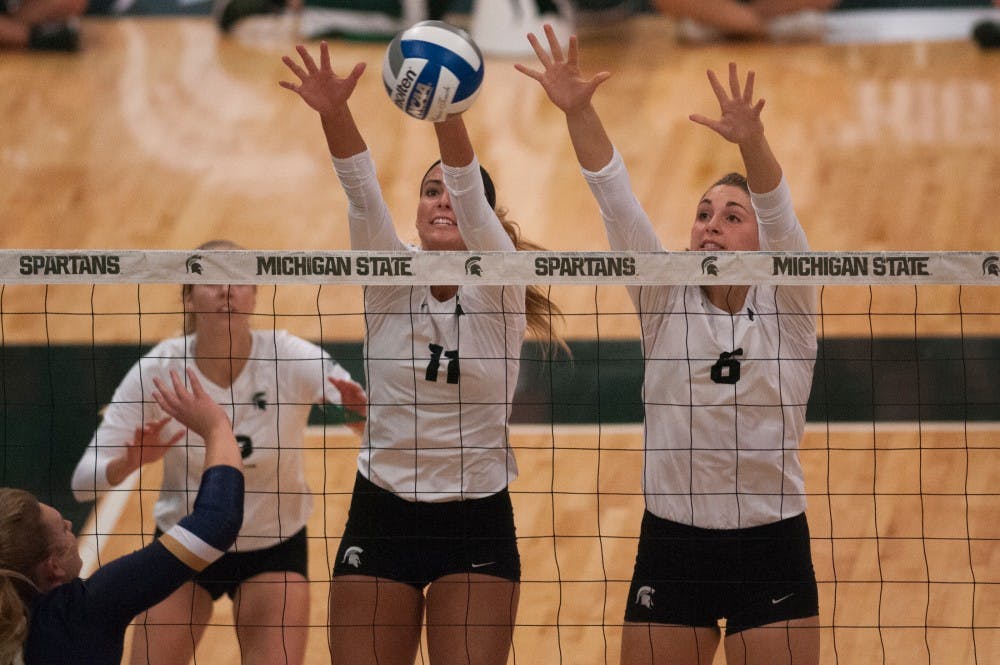Senior outside hitter Chloe Reinig (11) and Senior middle blocker Allyssah Fitterer (6) block the volleyball during the volleyball game against Notre Dame on Sept. 16, 2016 at Jenison Field House. The Spartans defeated the Fighting Irish, 3-0.