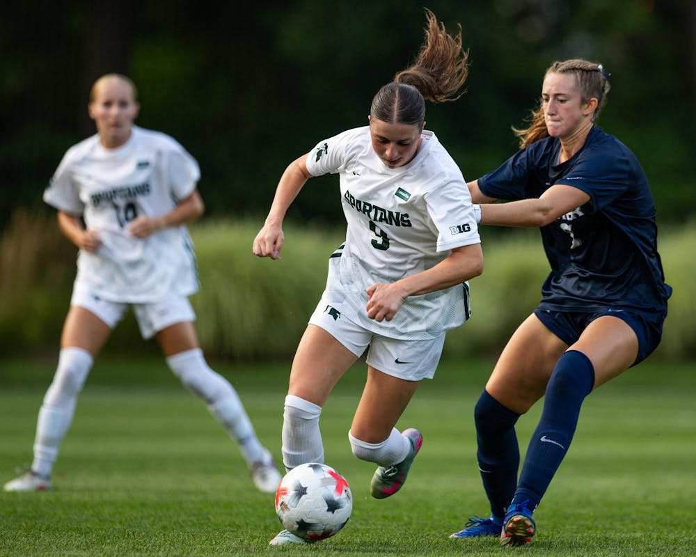 <p>Michigan State Sr. M, Kayla Briggs (9), gets pushed in the back from an opposing player while dribbling up the field in DeMartin Stadium in East Lansing, Mich., on Aug. 12, 2026.</p>