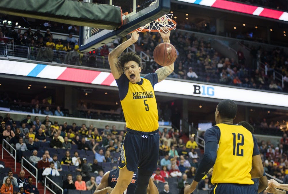 Junior forward D.J. Wilson (5) dunks the ball in the first half of the game against Illinois during the second round of the Big Ten Tournament on March 9, 2017 at Verizon Center in Washington D.C. The Wolverines are up at half time, 40-29.