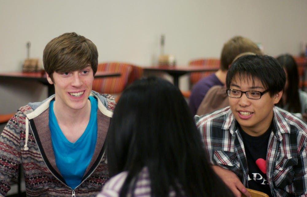 Japanese junior Joseph Canty, left, and sociology sophomore James Zhang speak with others at the Japanese Conversation Hour hosted by the Japan Club. Students met to spend time together and hone their Japanese speaking skills. Griffin Zotter/The State News