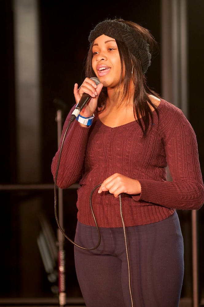 <p>Freshman arts and humanities student Camri Nelson sings during the open mic portion of the Speaking Like King poetry slam Jan. 17, 2015, at the International Center. The event was sponsored by the University Activities Board in honor of the Martin Luther King Jr. holiday weekend. Kelsey Feldpausch/ The State News.</p>