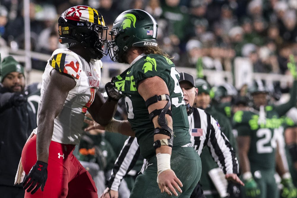 <p>Fifth-year defensive end Jacub Panasiuk (96) gets his shirt grabbed during the game against Maryland on Nov. 13, 2021, at Spartan Stadium. The Spartans defeated Maryland 40-21.</p>