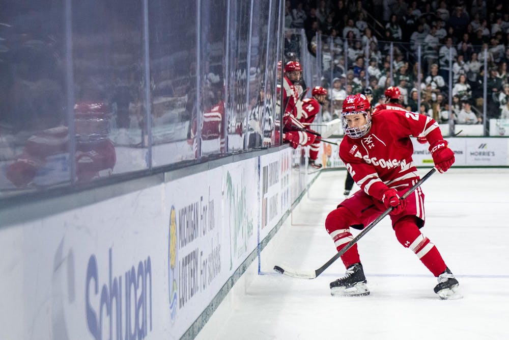 <p>Forward Jack Horbach (22) of Wisconsin moves the puck down the ice during a game against Michigan State University at Munn Ice Arena in East Lansing, Mich., on Saturday, Nov. 22, 2025.</p>