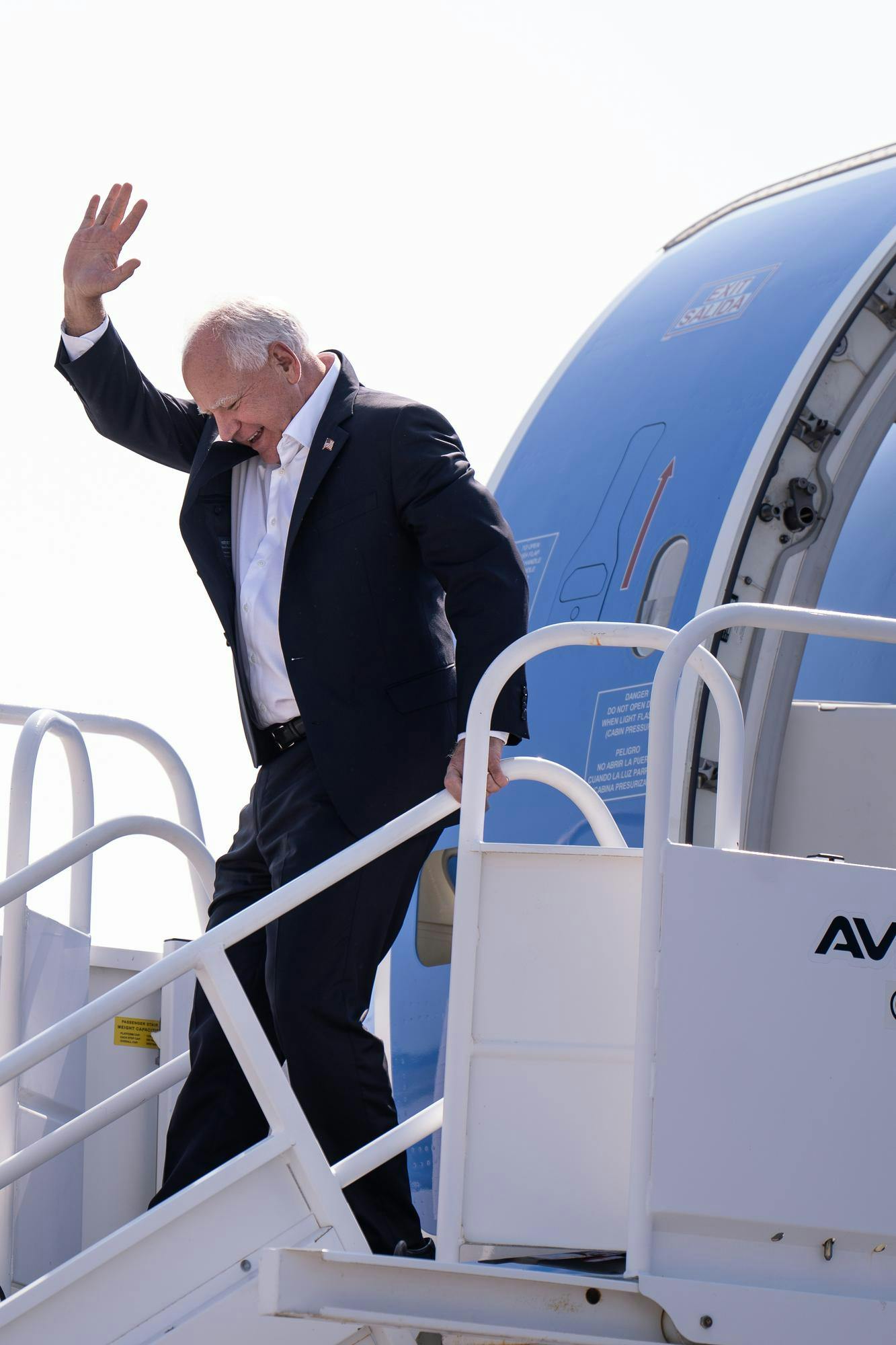 Minnesota Gov. Tim Walz arrives at the Capital Region International Airport in Lansing on Sept. 13, 2024.