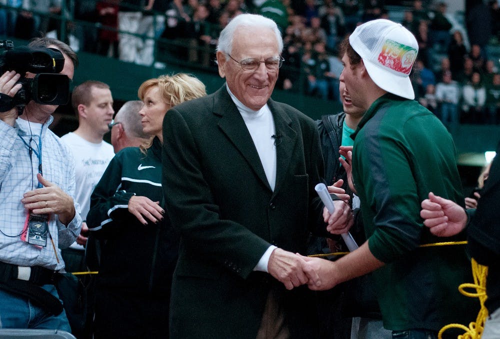 	<p>Gus Ganakas, coach of the Green team in the <span class="caps">MSU</span> men&#8217;s basketball alumni game, shakes hands with fans as he walks onto the court Friday at Jenison Field House. Ganakas was the head coach of the <span class="caps">MSU</span> men&#8217;s basketball team from 1969-1976. Katie Stiefel/The State News</p>