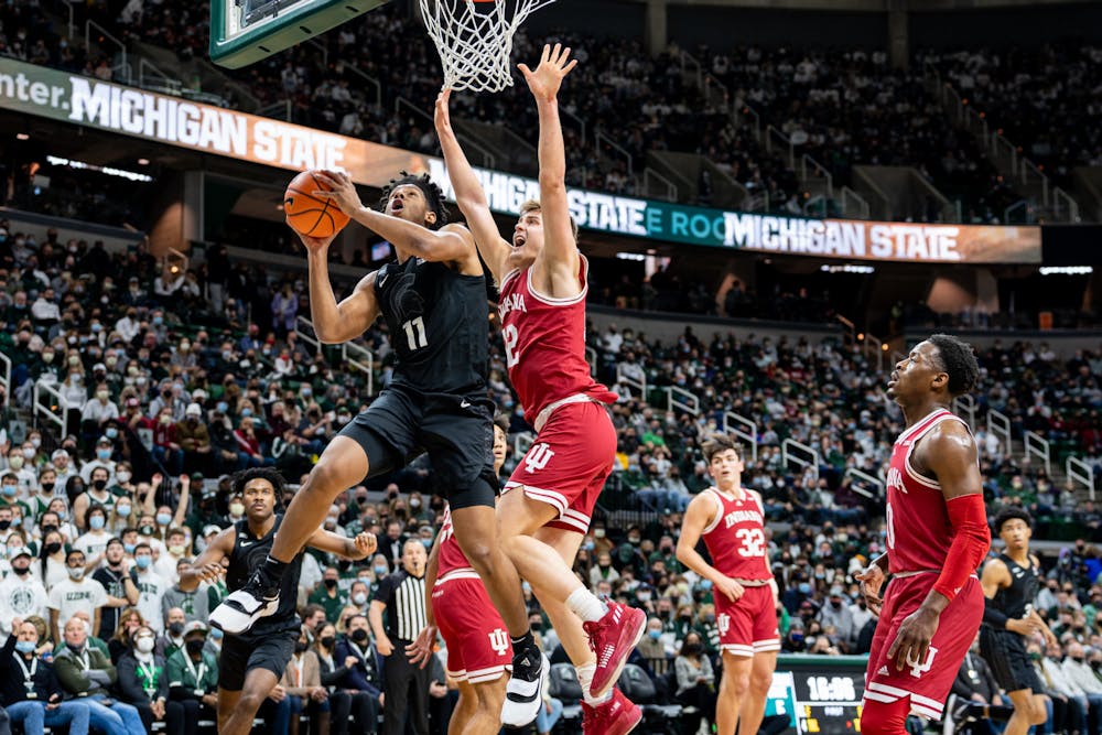 <p>Michigan State sophomore guard A.J. Hoggard (11) attempts to shoot the ball as Indiana&#x27;s senior forward Miller Kopp (12) attempts to block him on Feb. 12, 2022.</p>