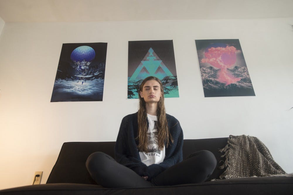 Environmental biology senior Mirijam Garske meditates to a reading of the poem '"All The Way" by Charles Bukowski on March 19, 2016 in her apartment in East Lansing. Garske has been meditating since she was in the 8th grade.