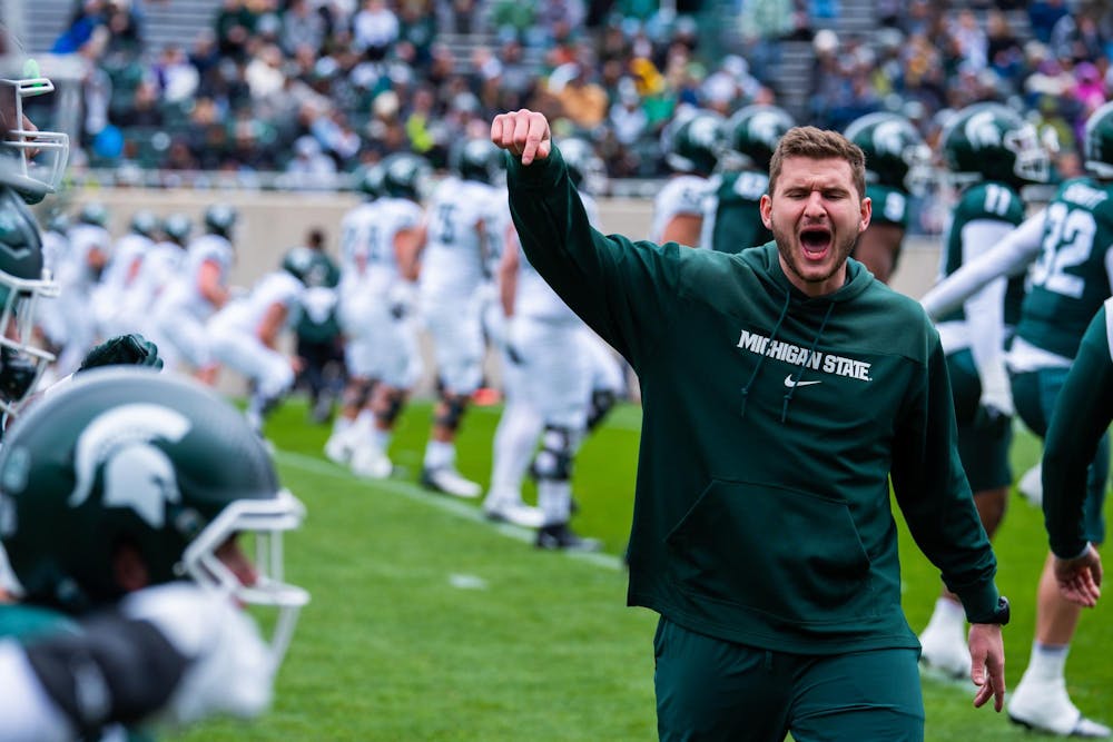 A member of the football coaching staff leads a team exercise during MSU football’s 2024 Spring Showcase on April 20, 2024.