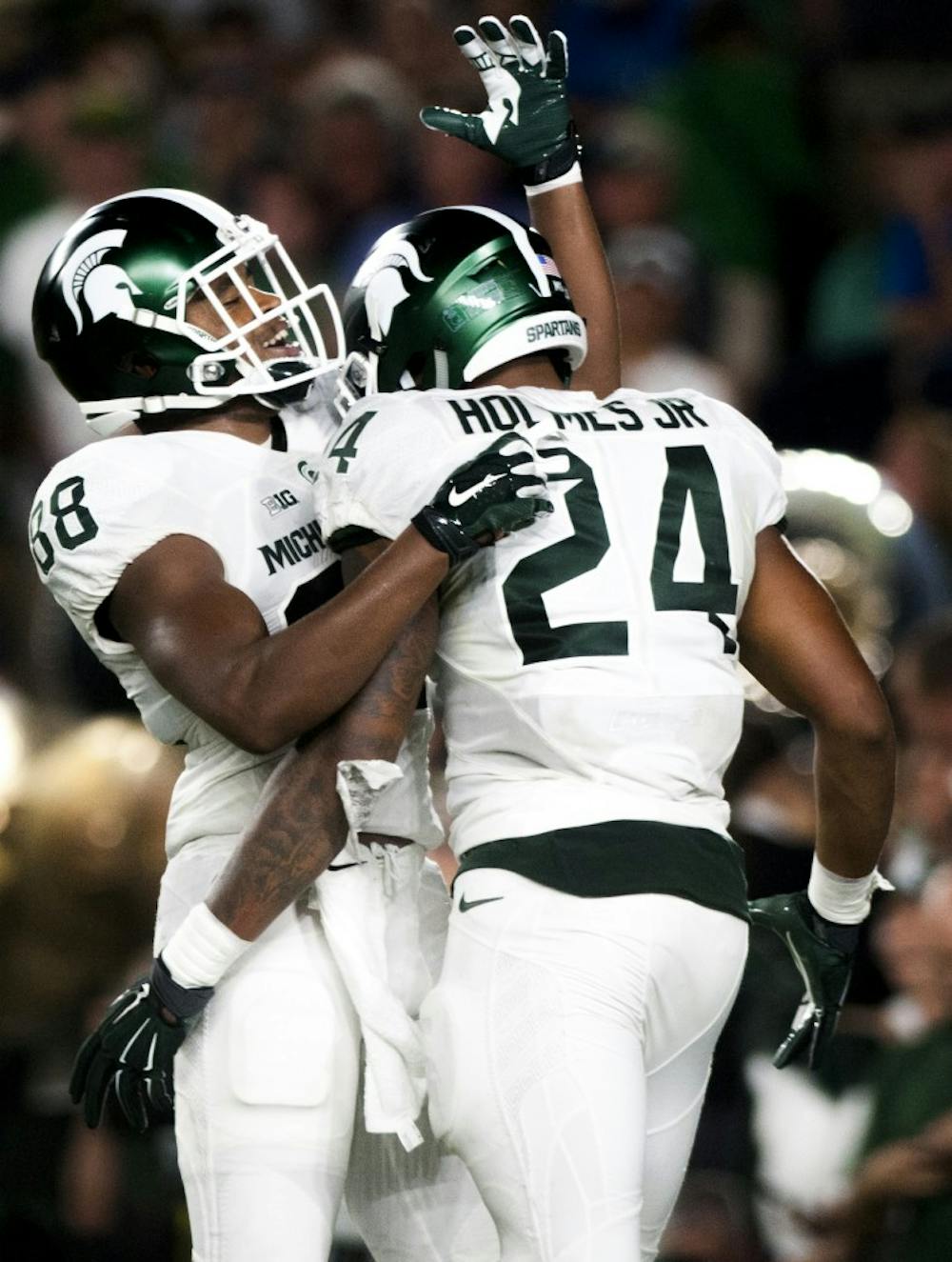 Senior wide receiver Monty Madaris (88) celebrates with junior running back Gerald Holmes (24) during the game against Notre Dame on Sept. 17, 2016 at Notre Dame Stadium in South Bend, Ind.  The Spartans defeated the Fighting Irish, 36-28. 