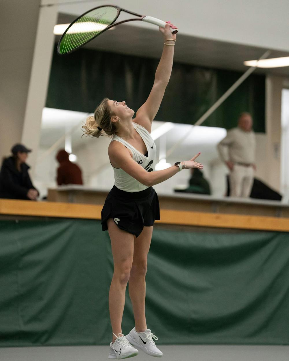 <p>MSU junior Issey Purser serves against Xavier in a singles match at the MSU Indoor Tennis Center on Jan. 24, 2025. Purser went on to lose the match.</p>