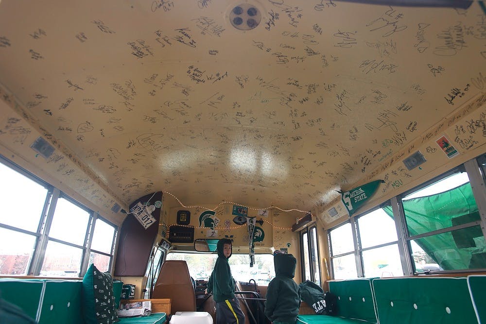 <p>Spartan fans tailgate around the spartan bus prior to the Green and White Spring game April 25, 2015, outside of Spartan Stadium. The bus is filled with spartan memorabilia and famous signatures. Hannah Levy/The State News</p>