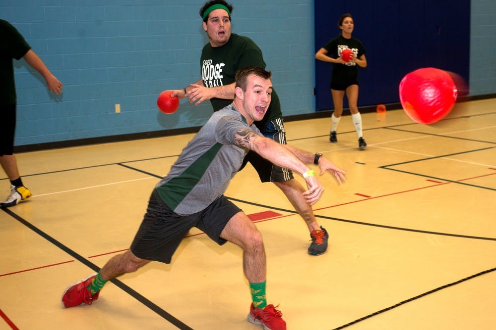 Lansing resident Logan Shanks throws the ball during a co-ed dodgeball game on Nov. 19, 2015 at Gier Community Center, 2400 Hall Street, in Lansing. Graduate students, MSU alumni and Lansing area residents alike gather every Thursday to play dodgeball and meet new people. 