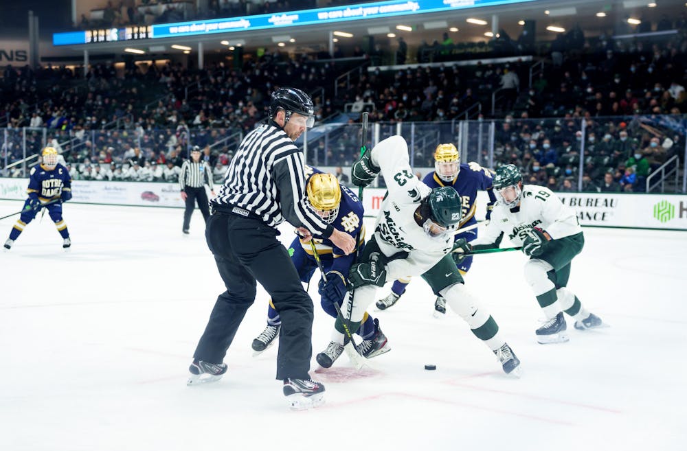 <p>Michigan State junior Jagger Joshua in a face-off against Notre Dame freshman Hunter Strand on Feb. 19, 2022. Spartans lost 4-2 against Notre Dame.</p>